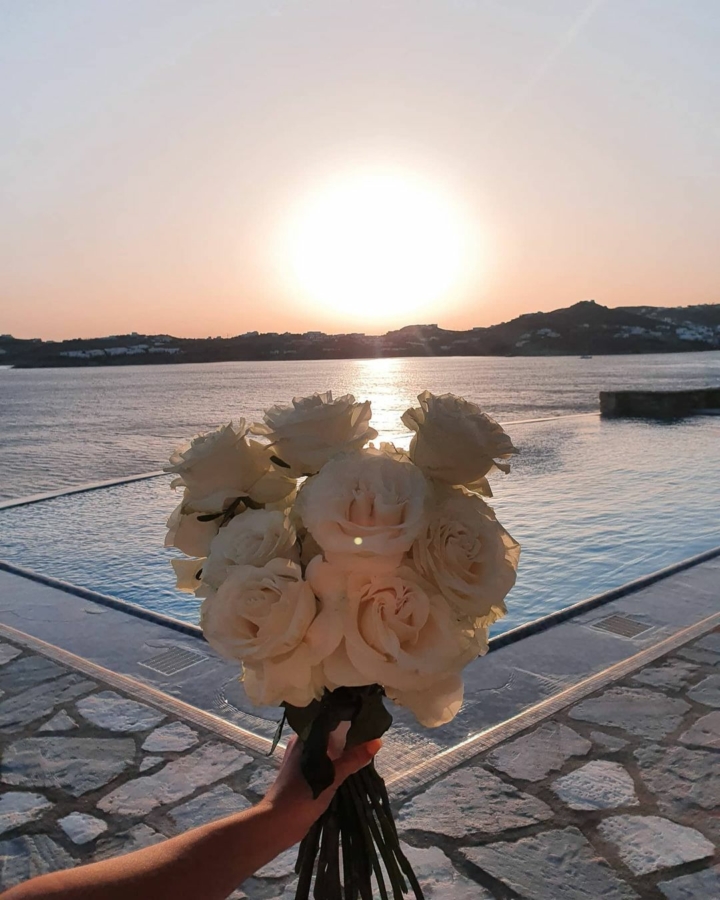 Bouquet and sunset during a Mykonos wedding vow renewal event at AGL Luxury Villas.