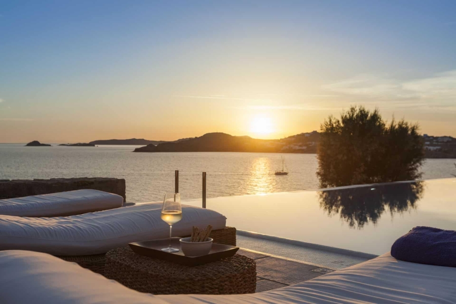 The sunset from the cliffs of Agios Lazaros, one of the best places regarding where to stay in Mykonos for privacy, expansive layouts and proximity to town