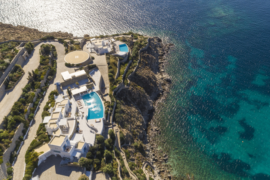 Aerial view of the AGL Luxury Villas complex perched on the cliffside of Agios Lazaros, featuring its private helipad and private jetty for yacht transfers and day trips from Mykonos.